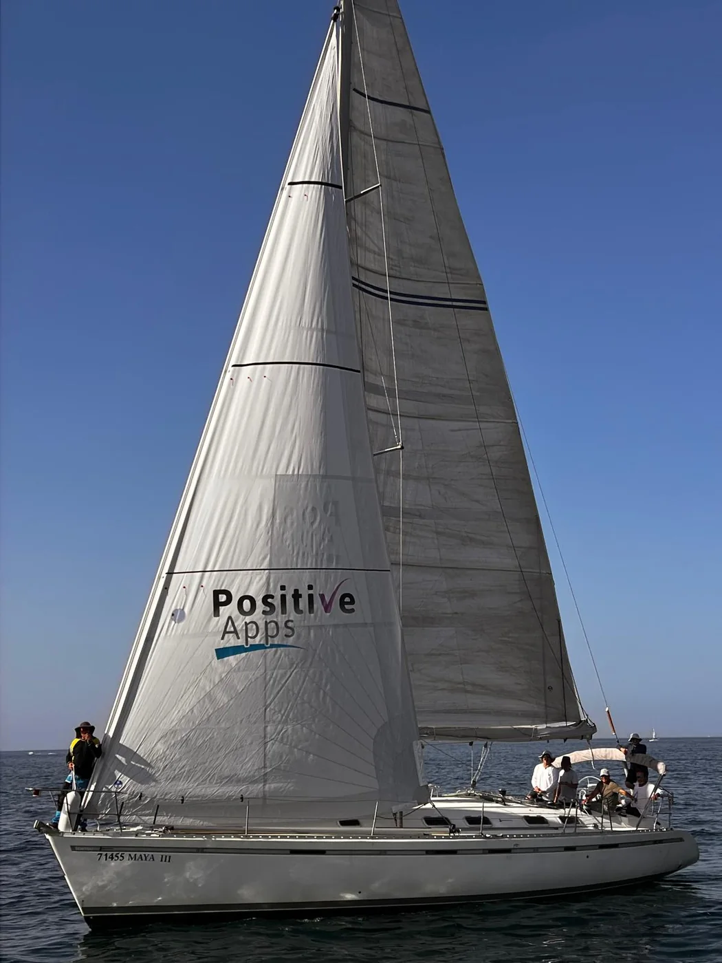 Ami Halfon's yacht, Maya III, sailing under full canvas with the Positive-Apps sail flying